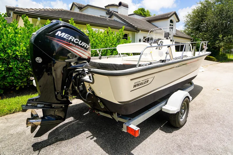 Slide: The Image of 2016 Boston Whaler 170 Montauk boat on trailer with Mercury outboard motor. - 21