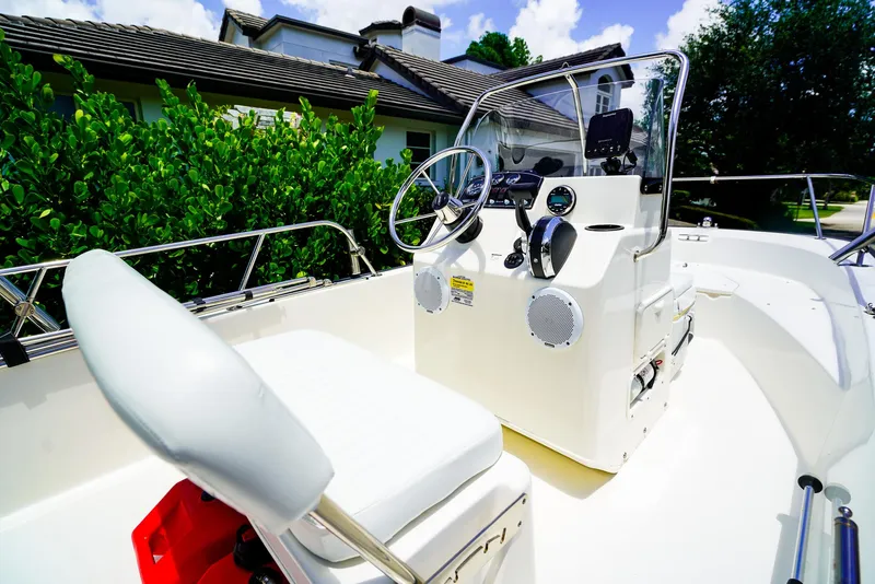 Slide: The Image of 2016 Boston Whaler 170 Montauk boat interior with steering console and seating. - 8
