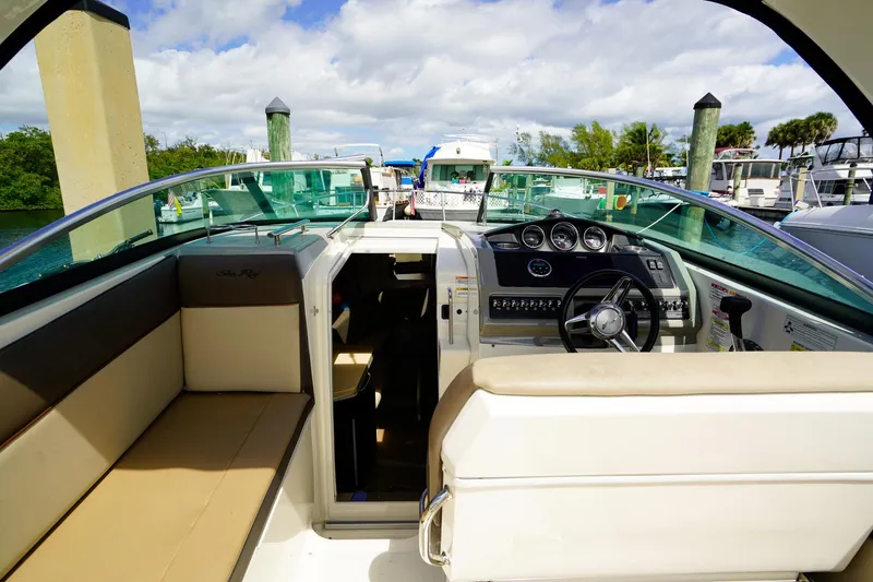 Slide: The Image of 2015 Sea Ray 260 Sundancer boat interior with helm and seating area. - 11
