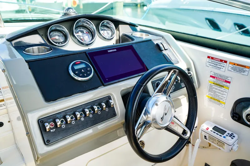 Slide: The Image of Control panel of 2015 Sea Ray 260 Sundancer boat with steering wheel and gauges. - 13