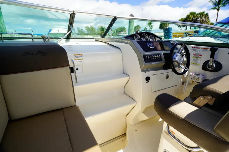 Slide: The Image of Interior view of 2015 Sea Ray 260 Sundancer boat cockpit with steering wheel and seating. - 16
