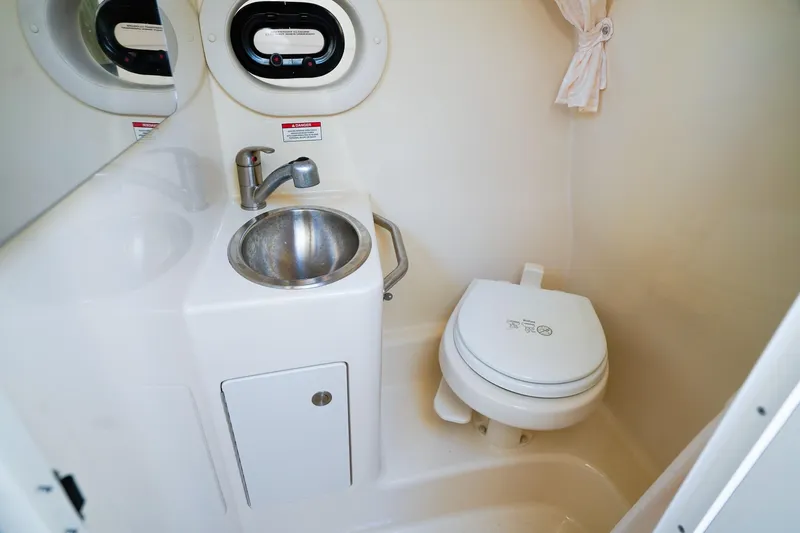 Slide: The Image of Compact bathroom in 2015 Sea Ray 260 Sundancer with sink and toilet. - 21