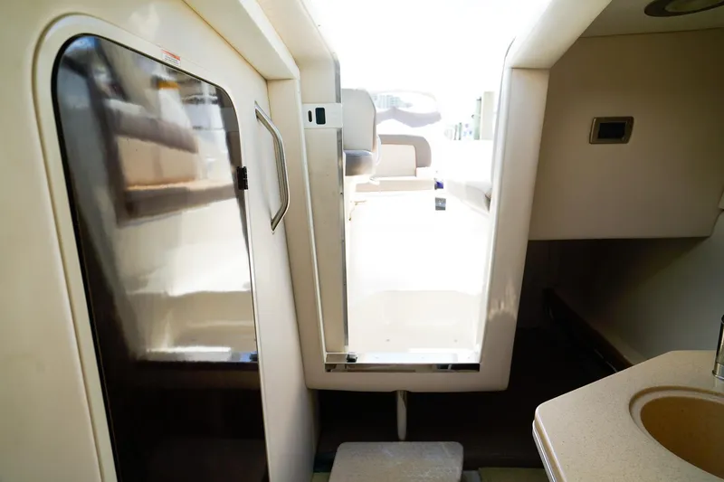 Slide: The Image of Interior view of 2015 Sea Ray 260 Sundancer cabin with seating and sink. - 24