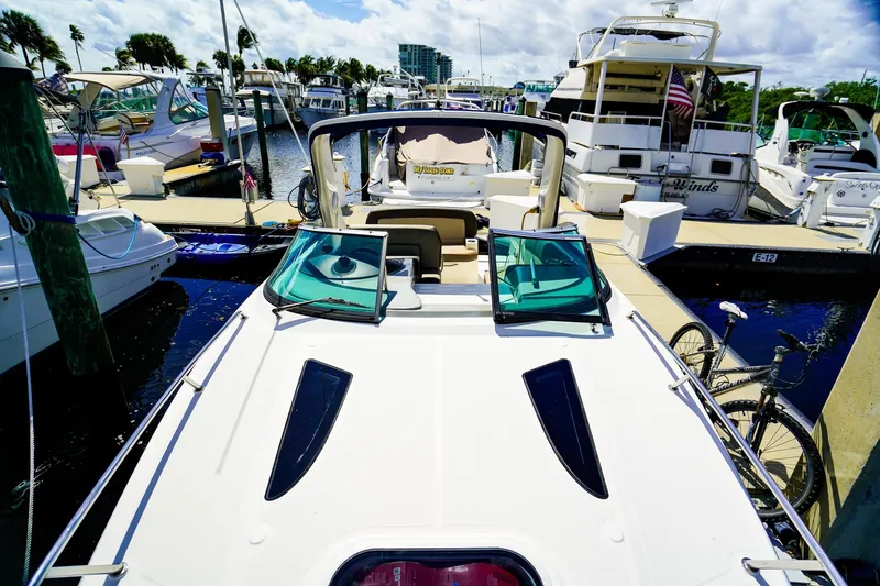 Slide: The Image of 2015 Sea Ray 260 Sundancer docked at a marina, surrounded by other boats. - 27
