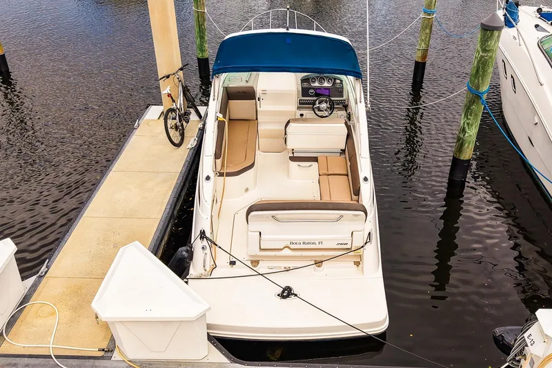 Slide: The Image of 2015 Sea Ray 260 Sundancer docked at marina with bicycle on pier. - 3
