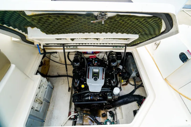Slide: The Image of Engine compartment of a 2015 Sea Ray 260 Sundancer boat, showcasing the engine and components. - 33