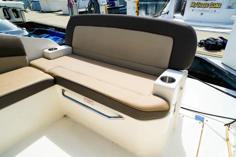 Slide: The Image of 2015 Sea Ray 260 Sundancer boat seating with cup holders, docked at marina. - 8