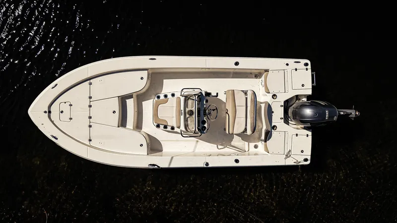 Slide: The Image of Overhead view of a 2016 Robalo 206 Cayman boat on dark water. - 2