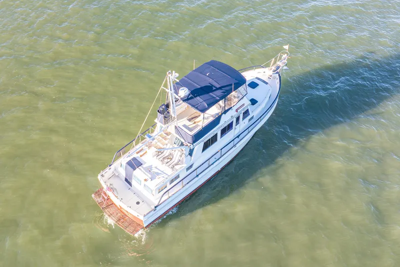 Slide: The Image of Aerial view of 1989 Grand Banks 46 Classic yacht cruising on calm waters. - 11