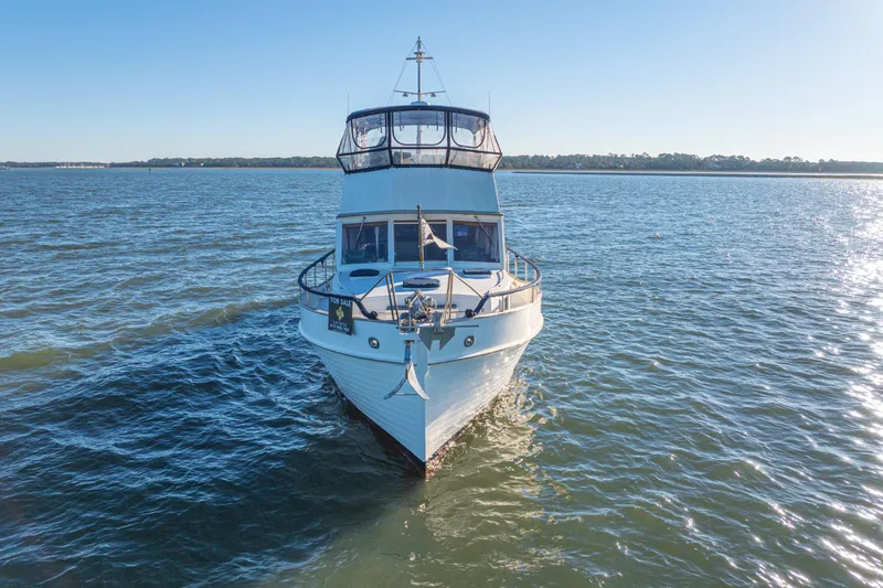 Slide: The Image of 1989 Grand Banks 46 Classic yacht on open water, clear sky, "For Sale" sign visible. - 14