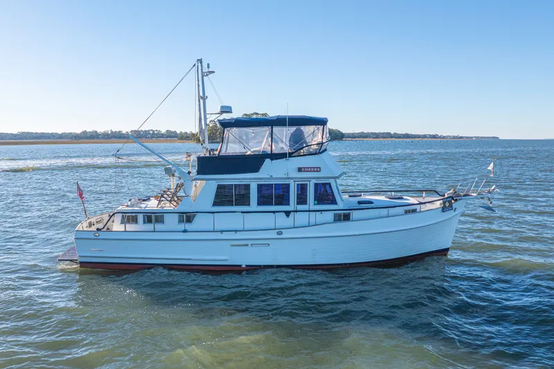 Slide: The Image of 1989 Grand Banks 46 Classic yacht cruising on open water under clear blue sky. - 15