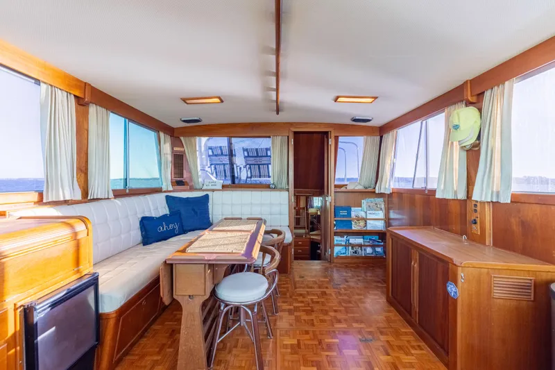 Slide: The Image of Interior of 1989 Grand Banks 46 Classic yacht with wood paneling and seating area. - 16