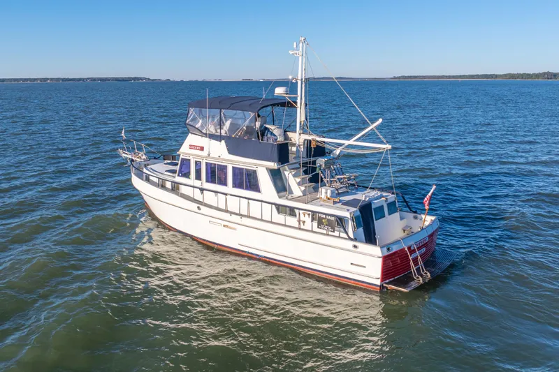Slide: The Image of 1989 Grand Banks 46 Classic yacht cruising on open water under clear skies. - 2