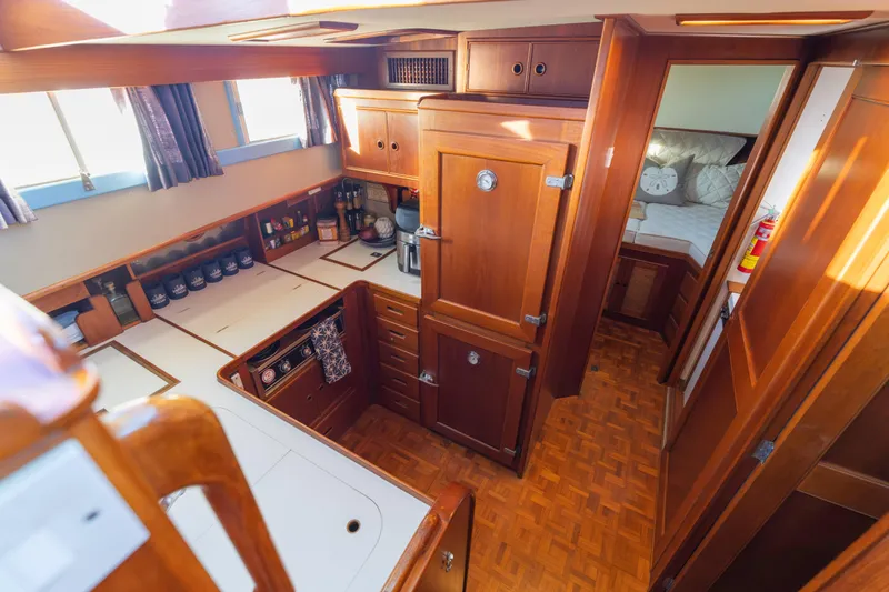 Slide: The Image of 1989 Grand Banks 46 Classic yacht interior with wooden cabinetry and cozy bedroom. - 26