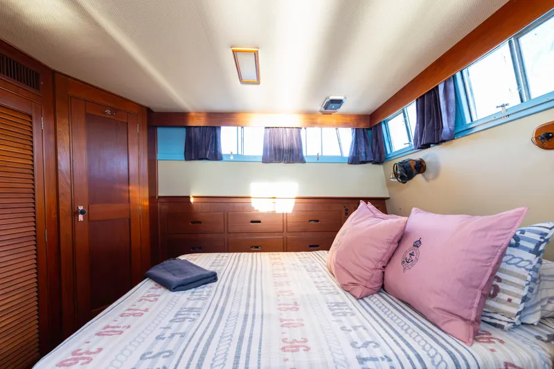 Slide: The Image of Cozy bedroom interior of 1989 Grand Banks 46 Classic yacht with wood paneling and nautical decor. - 28