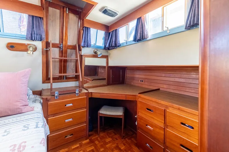 Slide: The Image of Interior of 1989 Grand Banks 46 Classic yacht with wooden cabinetry and desk area. - 30