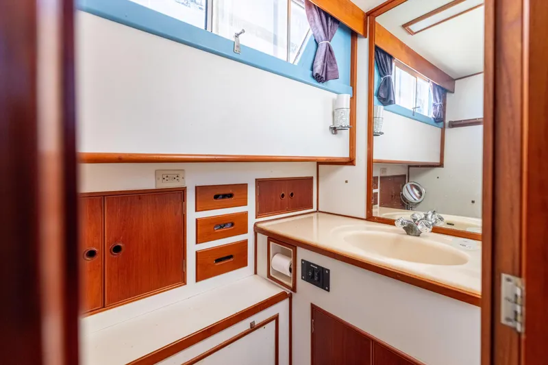 Slide: The Image of 1989 Grand Banks 46 Classic yacht bathroom with wood cabinetry and sink. - 31
