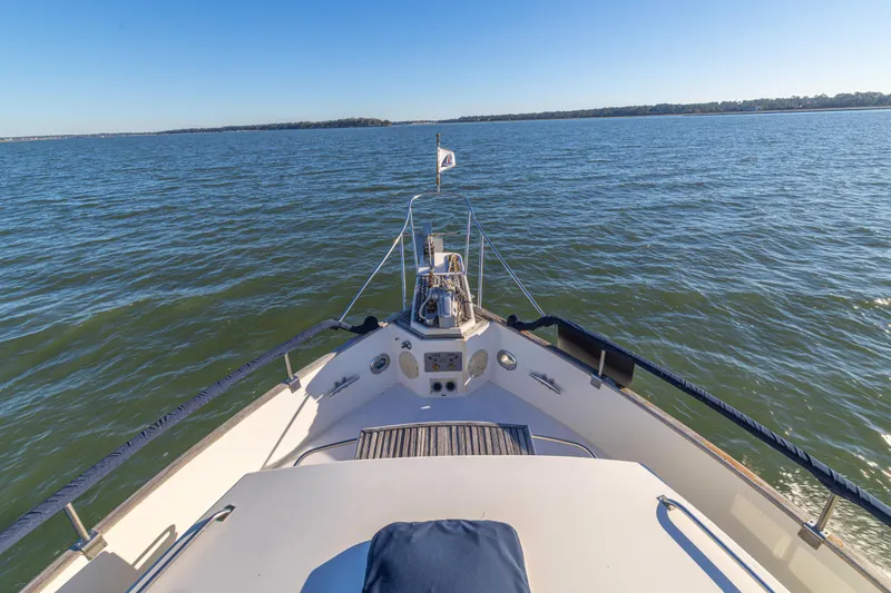 Slide: The Image of Bow view of 1989 Grand Banks 46 Classic yacht on open water. - 35