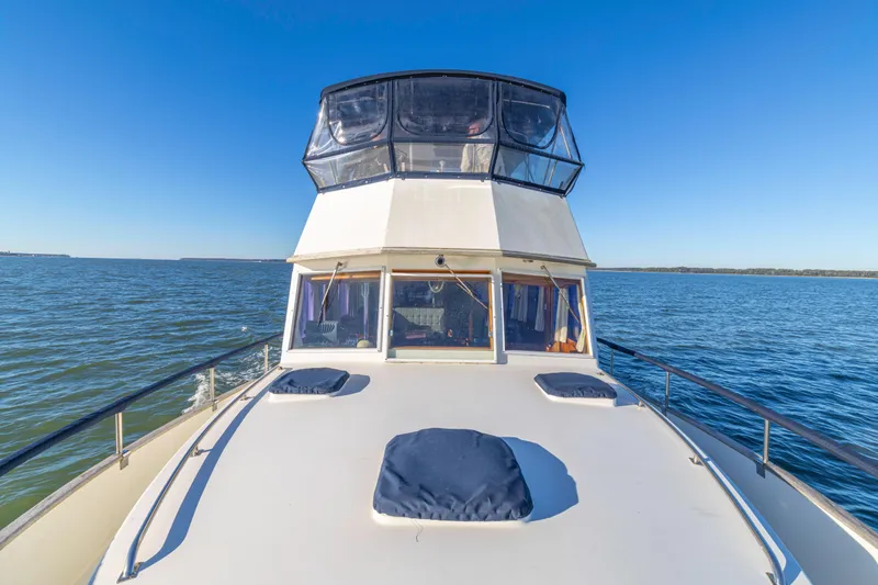 Slide: The Image of 1989 Grand Banks 46 Classic yacht cruising on open water under clear blue skies. - 37