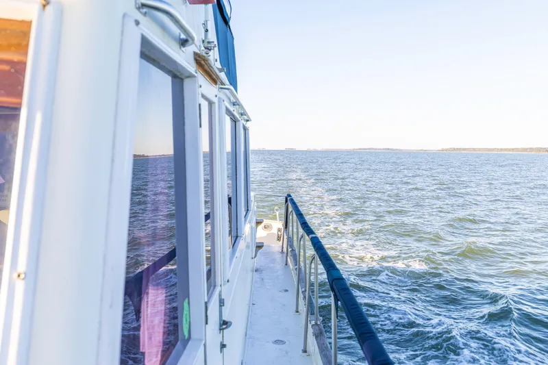 Slide: The Image of 1989 Grand Banks 46 Classic yacht cruising on open water, side view. - 38