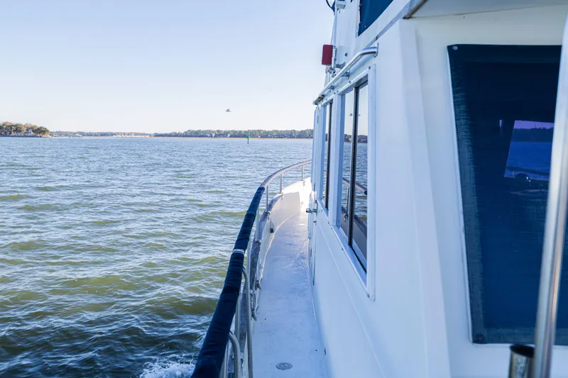 Slide: The Image of 1989 Grand Banks 46 Classic yacht cruising on calm waters under clear skies. - 40