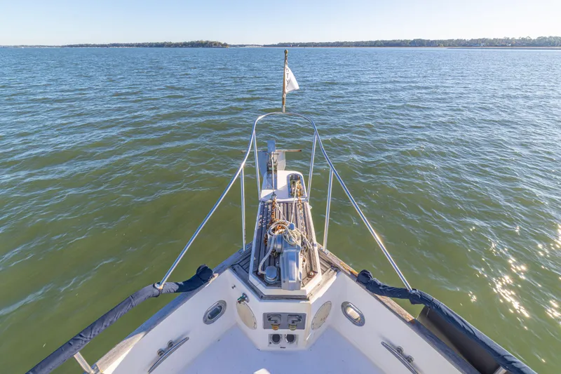 Slide: The Image of Bow view of 1989 Grand Banks 46 Classic yacht on calm waters. - 46
