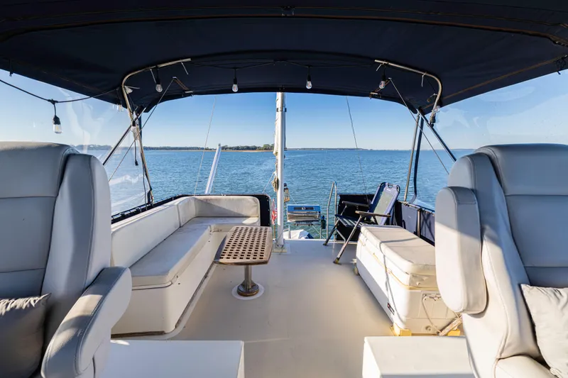 Slide: The Image of 1989 Grand Banks 46 Classic yacht interior with seating, table, and ocean view. - 54