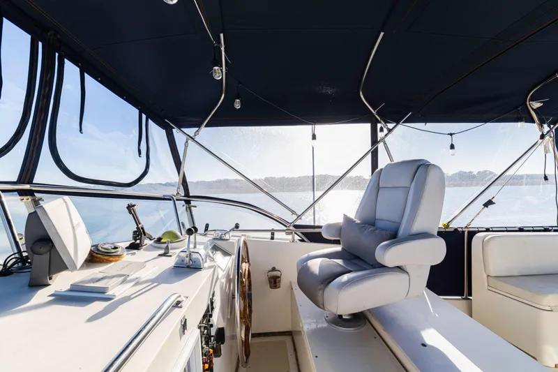 Slide: The Image of Interior helm of 1989 Grand Banks 46 Classic yacht with captain's chair and navigation equipment. - 59