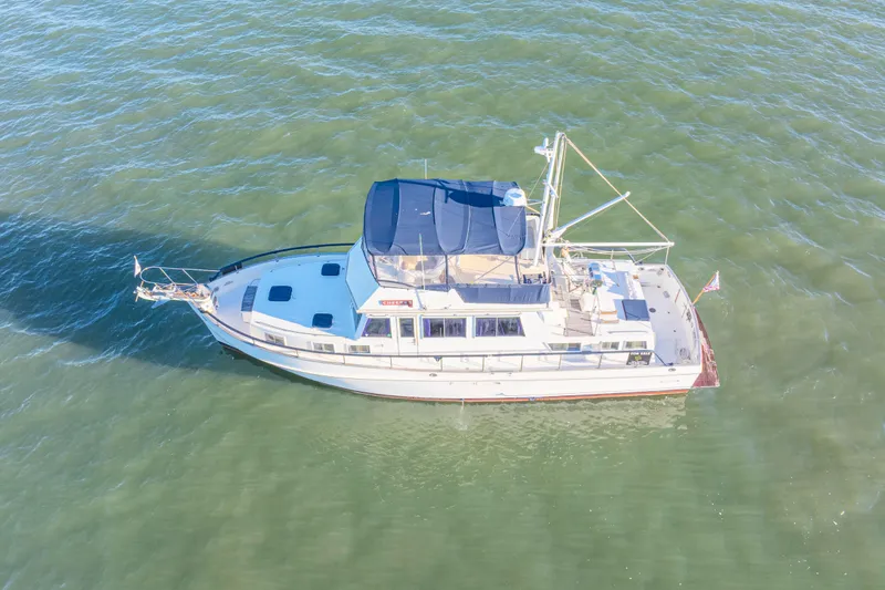 Slide: The Image of 1989 Grand Banks 46 Classic yacht cruising on open water, aerial view. - 8