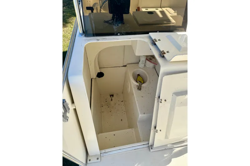 Slide: The Image of 2017 Beachcat 230 boat interior with open storage compartment and visible equipment. - 10