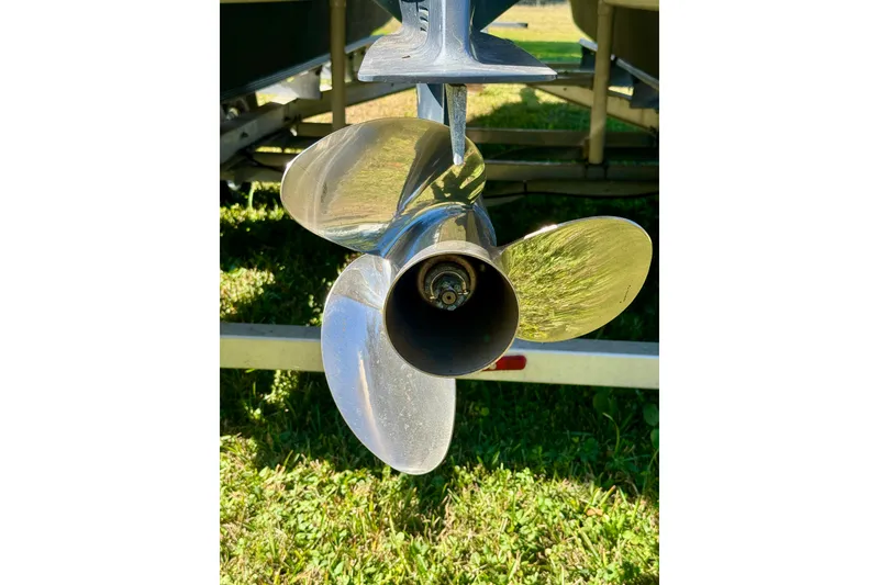 Slide: The Image of Close-up of a 2017 Beachcat 230 boat propeller on grass. - 17