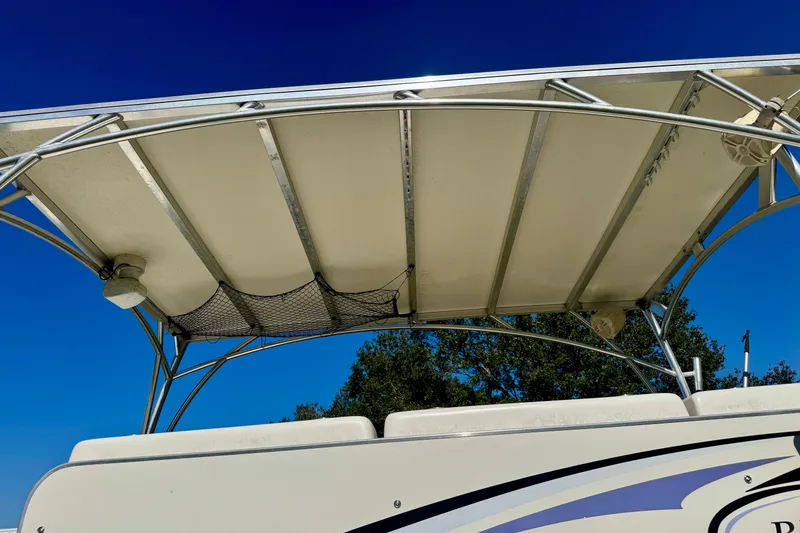 Slide: The Image of 2017 Beachcat 230 boat canopy with metal frame under clear blue sky. - 22