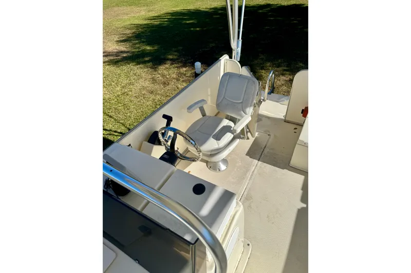 Slide: The Image of 2017 Beachcat 230 boat interior with steering wheel and captain's chair. - 8
