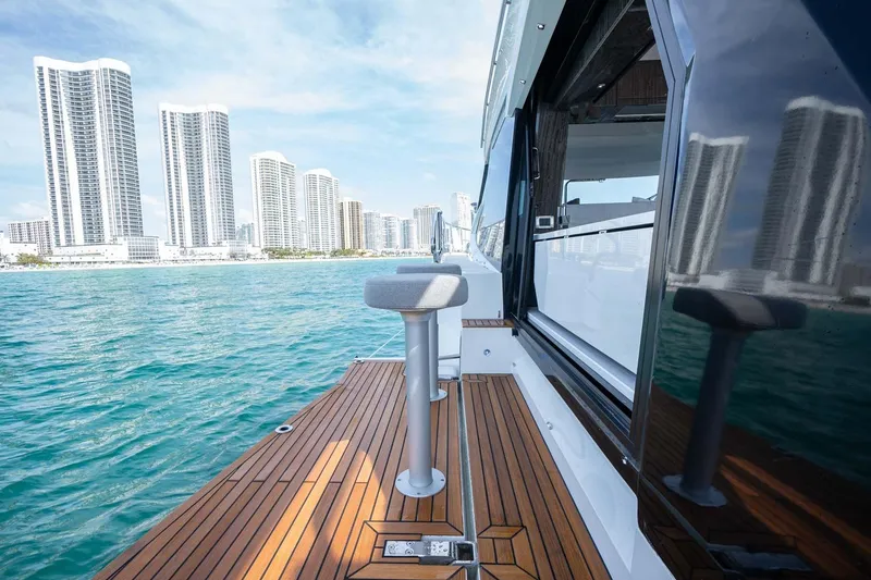 Slide: The Image of 2021 Galeon 500 Fly yacht with city skyline and ocean view. - 6