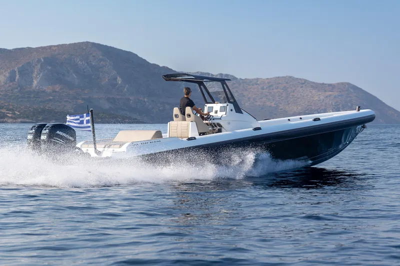 The Image of 2026 Rock Marine RM 36 speedboat cruising on open water with scenic mountain backdrop. - 0