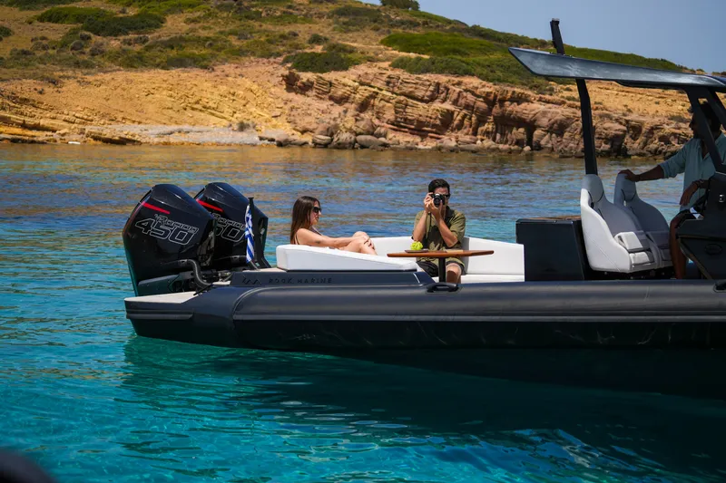 Slide: The Image of 2026 Rock Marine RM 36 boat on clear water, people relaxing and taking photos. - 12