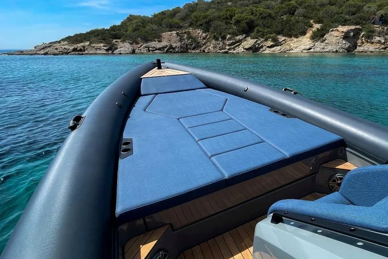 Slide: The Image of 2026 Rock Marine RM 36 boat on clear blue water near rocky coastline. - 15