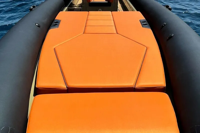 Slide: The Image of 2026 Rock Marine RM 36 boat with vibrant orange seating on calm water. - 16