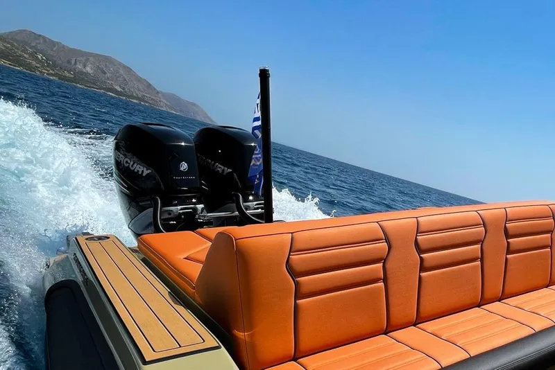 Slide: The Image of 2026 Rock Marine RM 36 boat with orange seating, cruising on open water. - 20