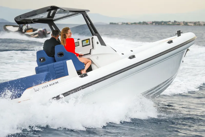 Slide: The Image of 2026 Rock Marine RM 36 speedboat cruising on open water with passengers. - 24
