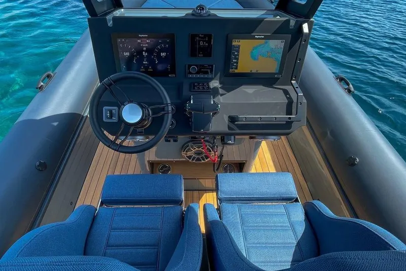 Slide: The Image of Cockpit of 2026 Rock Marine RM 36 boat with modern navigation system and blue seats. - 25