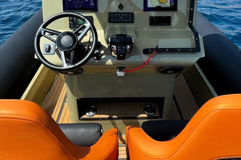 Slide: The Image of 2026 Rock Marine RM 36 boat cockpit with orange seats and modern controls. - 26
