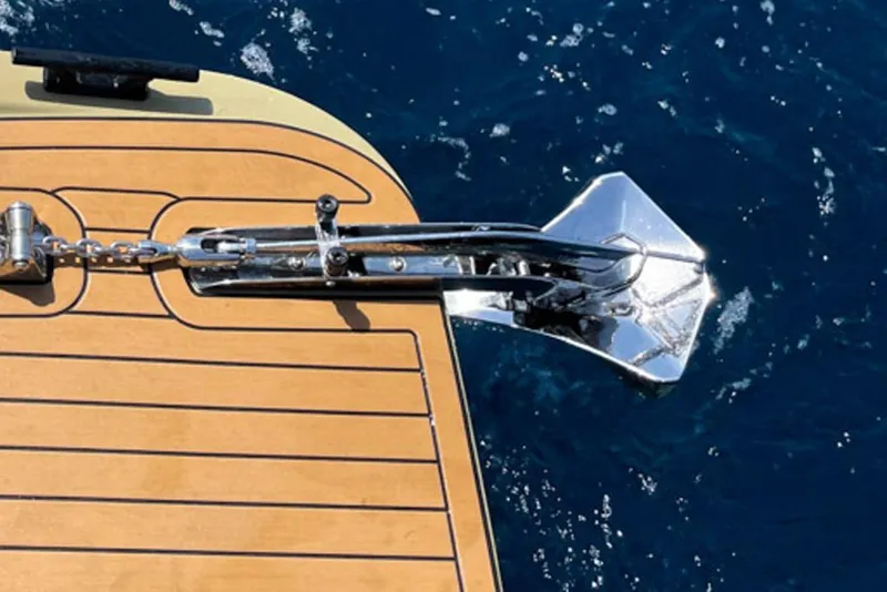 Slide: The Image of Anchor on Rock Marine RM 36 yacht, 2026 model, against deep blue sea. - 27