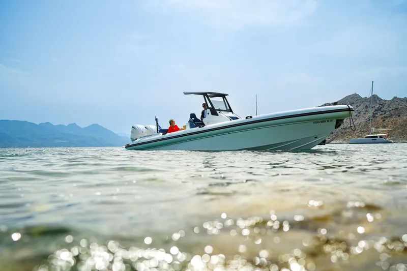 Slide: The Image of 2026 Rock Marine RM 36 boat cruising in clear waters near rocky coastline. - 8