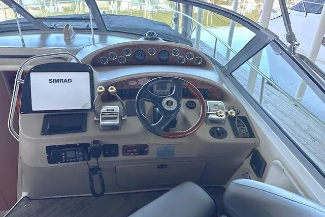 Slide: The Image of Helm of 2001 Sea Ray 340 Sundancer with Simrad navigation system and classic controls. - 12