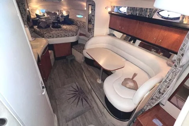 Slide: The Image of Interior of 2001 Sea Ray 340 Sundancer yacht with cozy seating and sleeping area. - 18