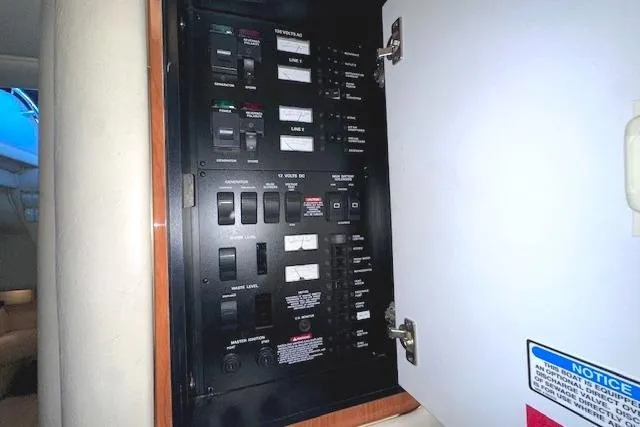 Slide: The Image of Electrical panel inside a 2001 Sea Ray 340 Sundancer boat, showing switches and controls. - 27