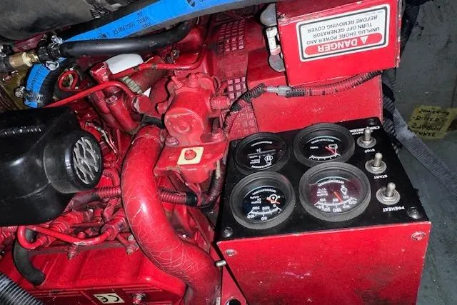 Slide: The Image of Engine compartment of a 2001 Sea Ray 340 Sundancer with gauges and red components. - 35