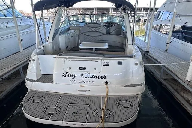 Slide: The Image of 2001 Sea Ray 340 Sundancer docked, rear view with seating and swim platform. - 4