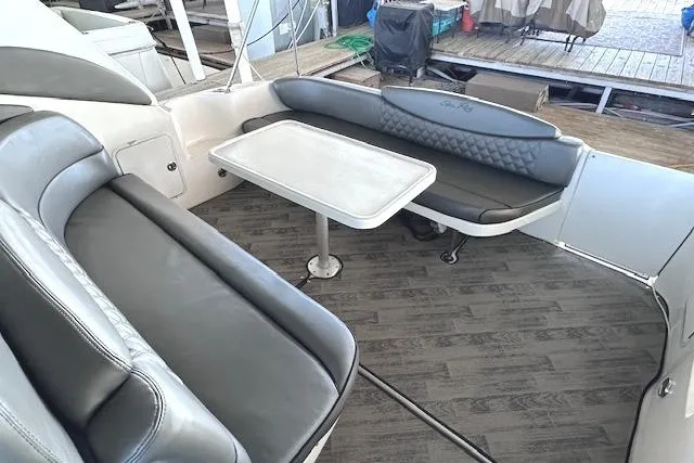 Slide: The Image of 2001 Sea Ray 340 Sundancer boat interior with gray seating and table. - 6